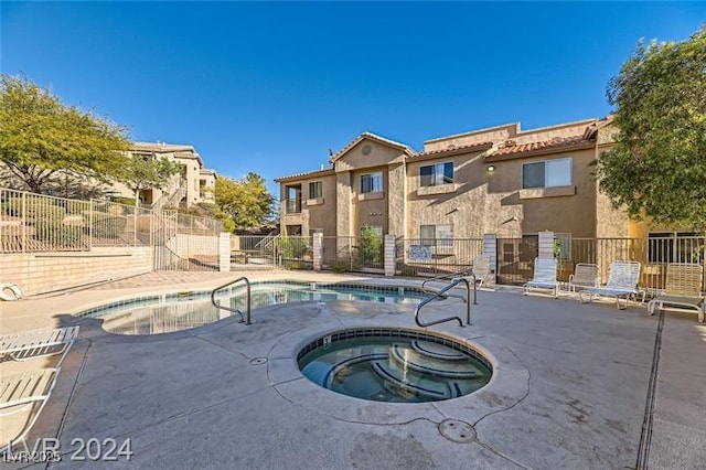 2110 Los Feliz St Unit 1066, Las Vegas, NV 89156 - community pool featuring a hot tub, fence, and a patio area
