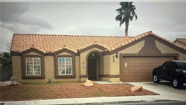 5020 Wildroot Rd, Las Vegas, NV 89130 - view of front of home featuring a tile roof, a garage, and driveway