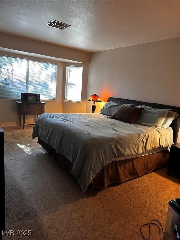 5020 Wildroot Rd, Las Vegas, NV 89130 - carpeted bedroom with a textured ceiling