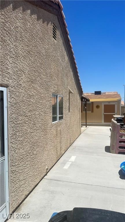 5020 Wildroot Rd, Las Vegas, NV 89130 - view of property exterior featuring stucco siding and a patio area