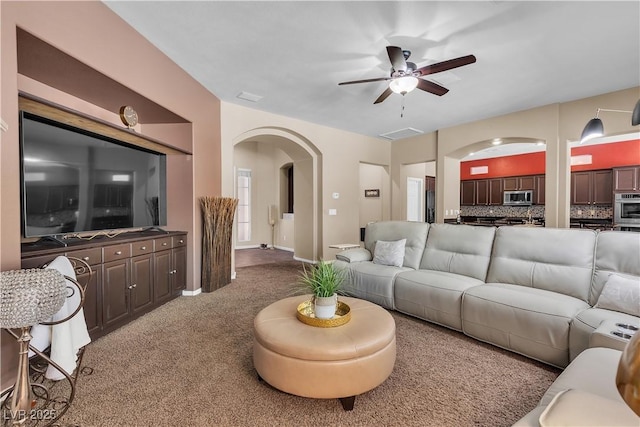 9362 Wilderness Glen Ave, Las Vegas, NV 89178 - carpeted living room with arched walkways and ceiling fan