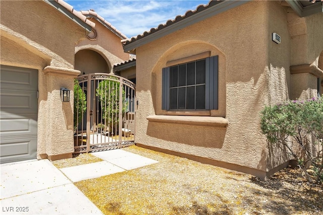 9362 Wilderness Glen Ave, Las Vegas, NV 89178 - entrance to property with a gate, stucco siding, and a tiled roof