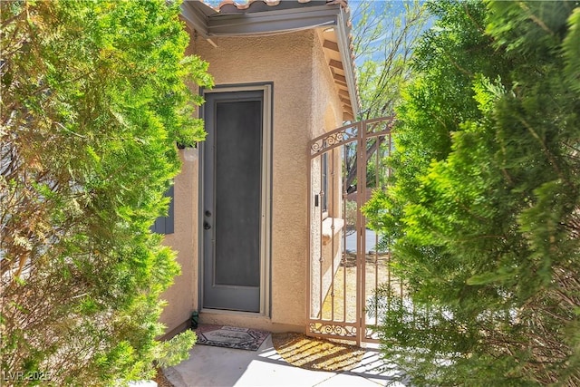9362 Wilderness Glen Ave, Las Vegas, NV 89178 - view of exterior entry with a gate and stucco siding