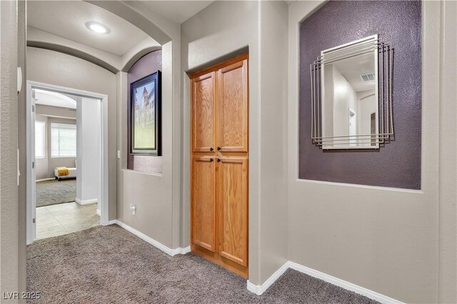 9362 Wilderness Glen Ave, Las Vegas, NV 89178 - hallway featuring carpet flooring, arched walkways, and baseboards
