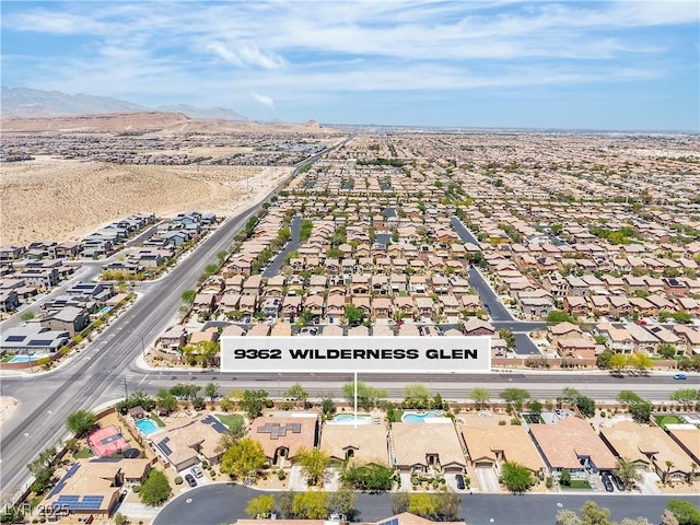 9362 Wilderness Glen Ave, Las Vegas, NV 89178 - aerial view of property and surrounding area featuring nearby suburban area and a mountain backdrop