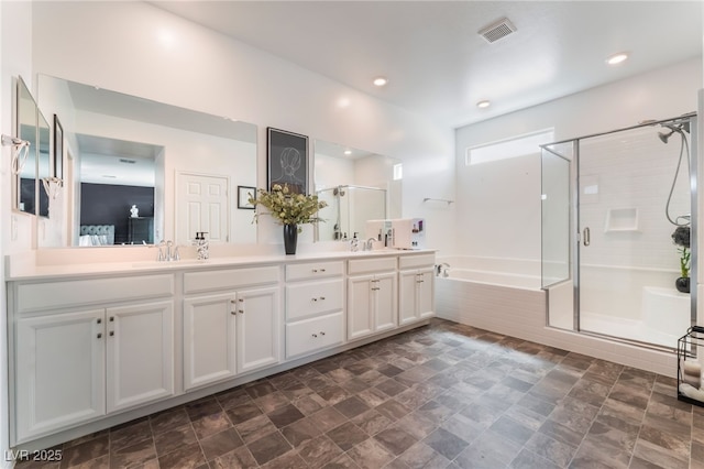 7107 Calvert Cliffs St, North Las Vegas, NV 89084 - full bathroom with a shower stall, a garden tub, double vanity, recessed lighting, and stone finish flooring