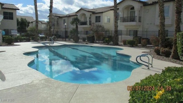 4821 Black Bear Rd Unit 104, Las Vegas, NV 89149 - community pool with fence, a patio, and a residential view