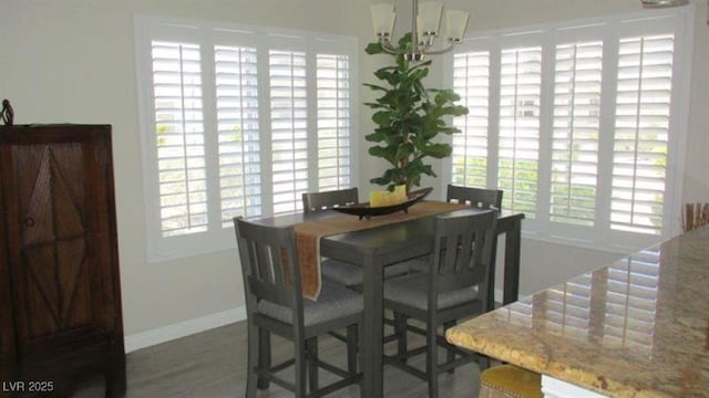 4821 Black Bear Rd Unit 104, Las Vegas, NV 89149 - dining area with a chandelier, baseboards, and wood finished floors