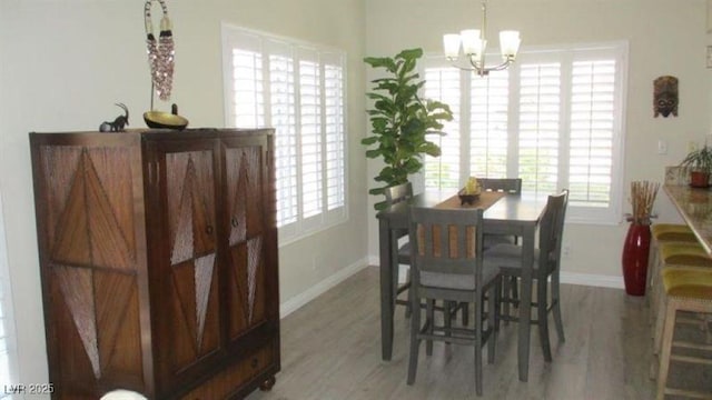 4821 Black Bear Rd Unit 104, Las Vegas, NV 89149 - dining area with a chandelier, baseboards, and wood finished floors
