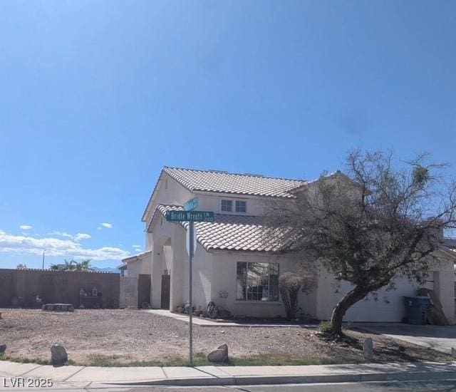 2147 Bridle Wreath Ln, Las Vegas, NV 89156 - back of property featuring stucco siding, a tile roof, and a garage