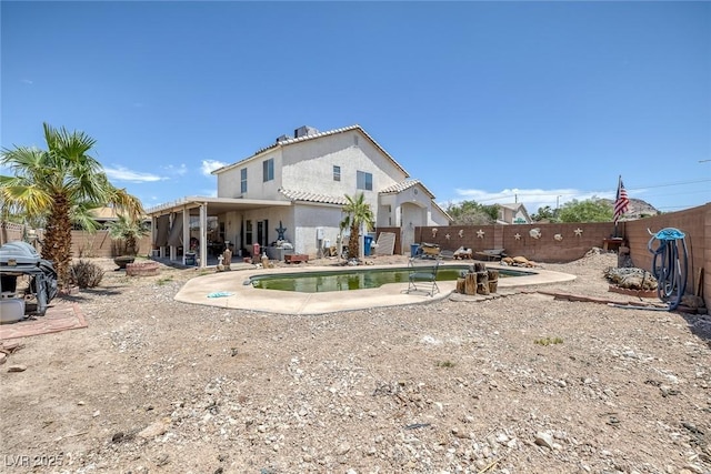 2147 Bridle Wreath Ln, Las Vegas, NV 89156 - back of property featuring a fenced backyard, stucco siding, and a patio area