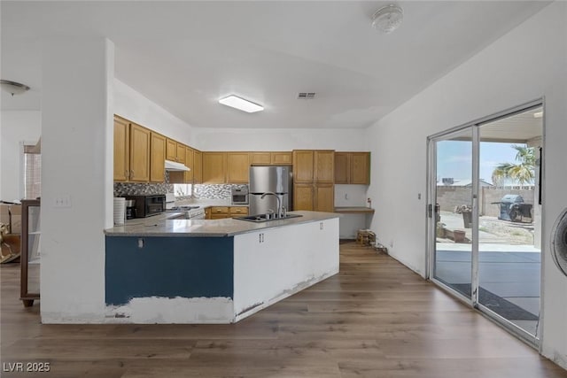 2147 Bridle Wreath Ln, Las Vegas, NV 89156 - kitchen featuring freestanding refrigerator, white gas range oven, a sink, under cabinet range hood, and wood finished floors