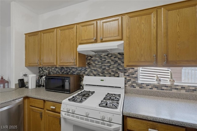 2147 Bridle Wreath Ln, Las Vegas, NV 89156 - kitchen featuring white gas range, under cabinet range hood, dishwasher, black microwave, and light countertops