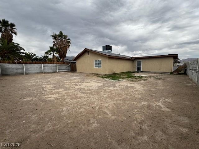 4189 Studio St, Las Vegas, NV 89115 - rear view of property with a fenced backyard and stucco siding