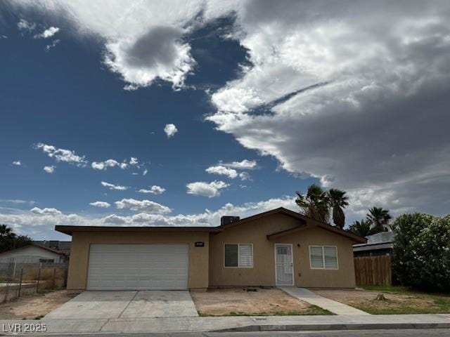 4189 Studio St, Las Vegas, NV 89115 - ranch-style home with stucco siding, an attached garage, fence, and concrete driveway