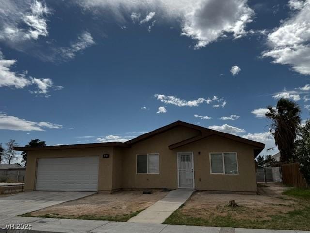 4189 Studio St, Las Vegas, NV 89115 - ranch-style home featuring stucco siding, an attached garage, fence, and concrete driveway