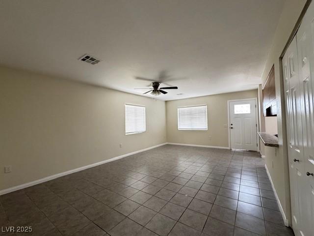 4189 Studio St, Las Vegas, NV 89115 - spare room featuring a ceiling fan, dark tile patterned flooring, and baseboards