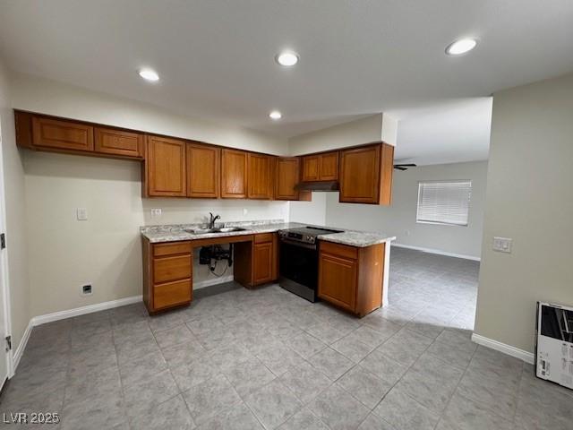 4189 Studio St, Las Vegas, NV 89115 - kitchen with electric range, brown cabinetry, a sink, light countertops, and baseboards