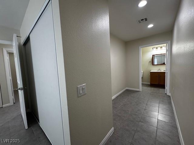 4189 Studio St, Las Vegas, NV 89115 - corridor featuring tile patterned flooring, recessed lighting, baseboards, and a sink