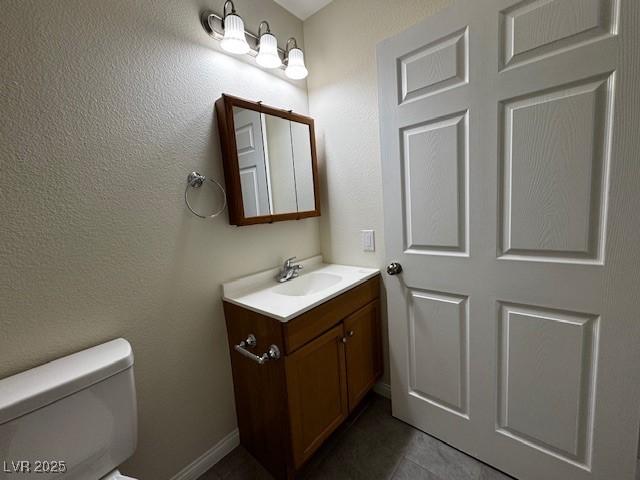 4189 Studio St, Las Vegas, NV 89115 - half bathroom with toilet, vanity, and tile patterned floors