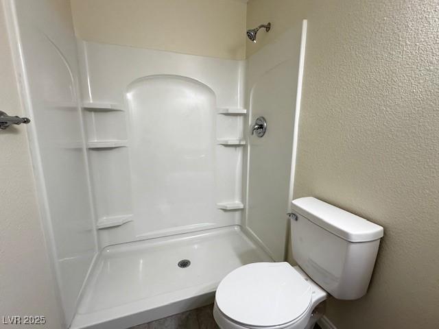 4189 Studio St, Las Vegas, NV 89115 - full bathroom featuring a textured wall, a shower, and toilet