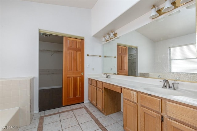 1924 Coralino Dr, Henderson, NV 89074 - full bath featuring tile patterned flooring, double vanity, vaulted ceiling, a tub, and inlaid floor details