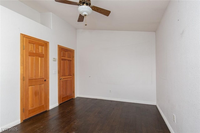 1924 Coralino Dr, Henderson, NV 89074 - spare room with dark wood-type flooring, vaulted ceiling, baseboards, and ceiling fan