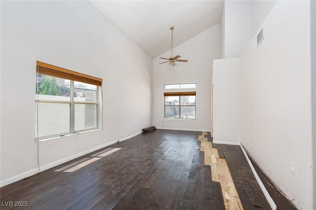 1924 Coralino Dr, Henderson, NV 89074 - unfurnished living room featuring dark wood-type flooring, high vaulted ceiling, ceiling fan, and baseboards