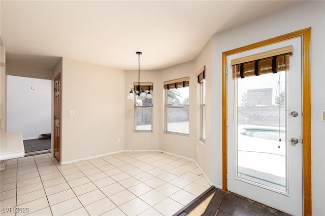 1924 Coralino Dr, Henderson, NV 89074 - unfurnished dining area with a chandelier, light tile patterned floors, and baseboards