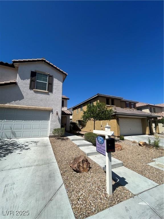 9082 Amanda Creek Ct, Las Vegas, NV 89149 - traditional-style home featuring a garage, stucco siding, concrete driveway, and a tiled roof