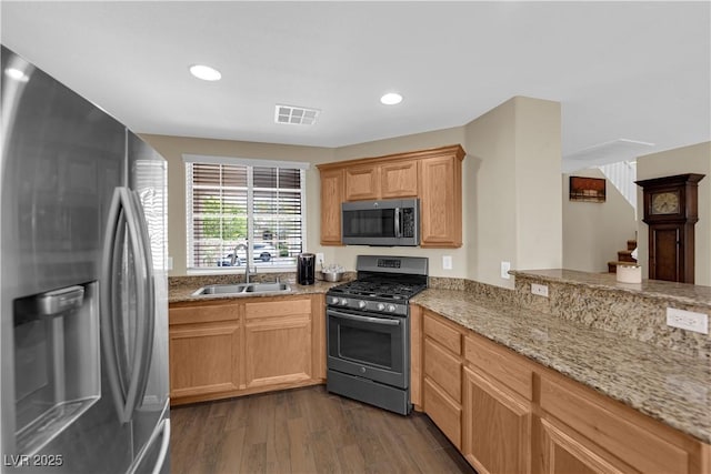 9082 Amanda Creek Ct, Las Vegas, NV 89149 - kitchen with stainless steel appliances, a sink, dark wood finished floors, light stone countertops, and recessed lighting