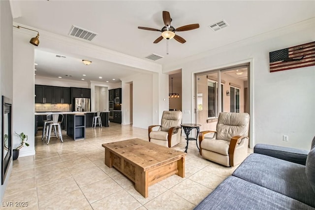 7404 Eggshell Dr, North Las Vegas, NV 89084 - living room with light tile patterned floors, crown molding, and ceiling fan