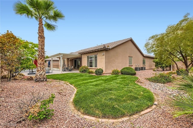 7404 Eggshell Dr, North Las Vegas, NV 89084 - rear view of property with stucco siding, a yard, and a patio