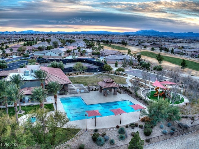 7404 Eggshell Dr, North Las Vegas, NV 89084 - community pool featuring a mountain view, fence, a patio area, and a residential view