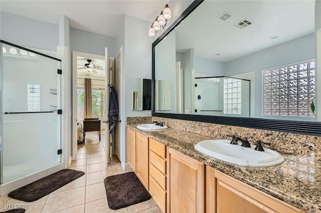 7404 Eggshell Dr, North Las Vegas, NV 89084 - bathroom with tile patterned flooring, a shower stall, a ceiling fan, double vanity, and ensuite bath
