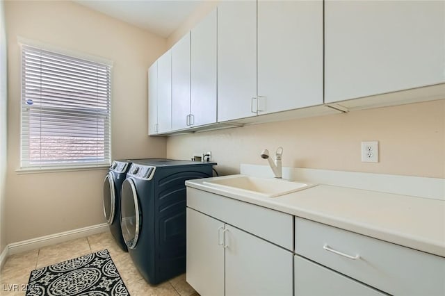7404 Eggshell Dr, North Las Vegas, NV 89084 - clothes washing area with cabinet space, separate washer and dryer, baseboards, and light tile patterned floors