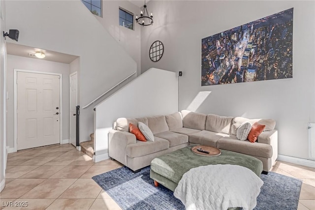 7912 Horn Beam Ct, Las Vegas, NV 89131 - living area featuring light tile patterned flooring, baseboards, a chandelier, and a high ceiling