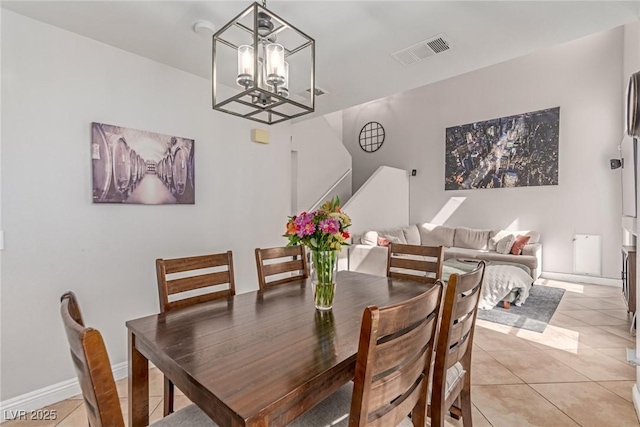 7912 Horn Beam Ct, Las Vegas, NV 89131 - dining area featuring a chandelier, light tile patterned floors, stairway, and baseboards