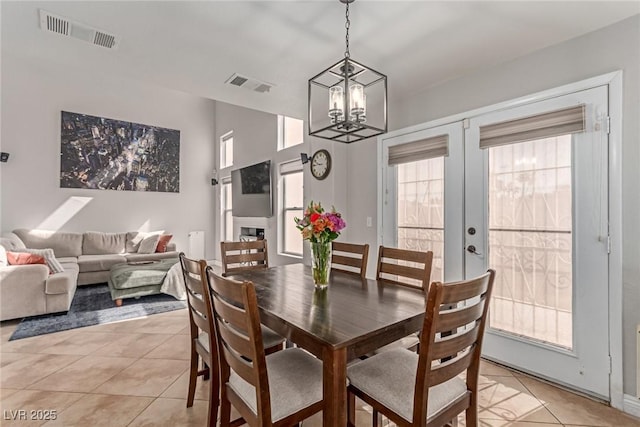 7912 Horn Beam Ct, Las Vegas, NV 89131 - dining room featuring light tile patterned flooring, a chandelier, french doors, and baseboards