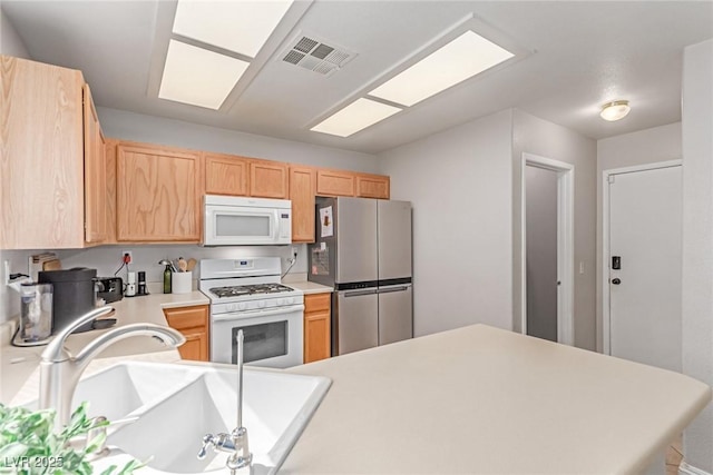 7912 Horn Beam Ct, Las Vegas, NV 89131 - kitchen with white appliances, a sink, light brown cabinetry, light countertops, and a peninsula