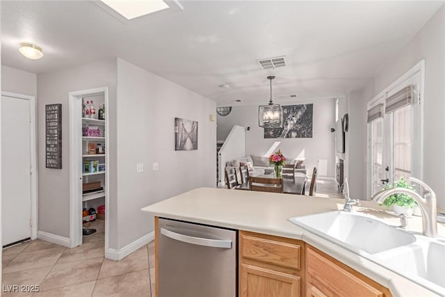7912 Horn Beam Ct, Las Vegas, NV 89131 - kitchen with stainless steel dishwasher, a sink, light tile patterned floors, light countertops, and a chandelier