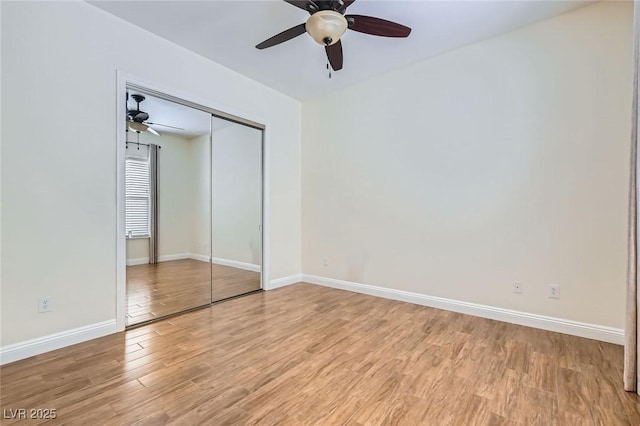 3805 Specula Wing Dr, North Las Vegas, NV 89084 - unfurnished bedroom with light wood-style flooring, baseboards, a closet, and ceiling fan