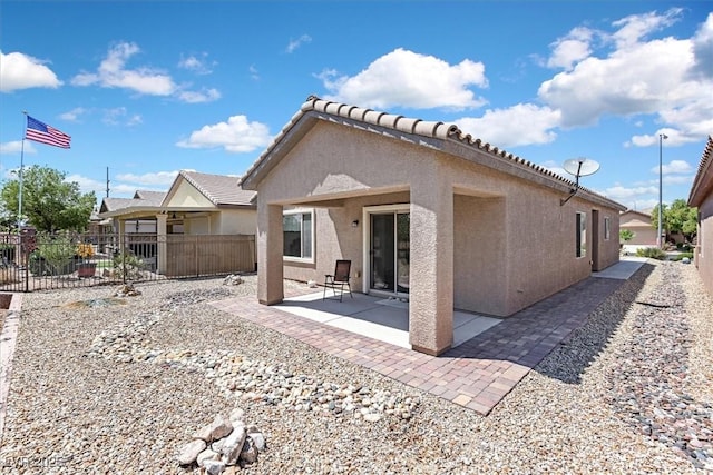6039 Tokara Ave, Las Vegas, NV 89122 - rear view of property featuring stucco siding and a patio area