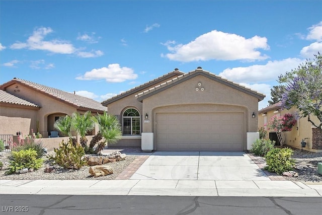 6039 Tokara Ave, Las Vegas, NV 89122 - mediterranean / spanish-style house featuring a garage, stucco siding, and concrete driveway