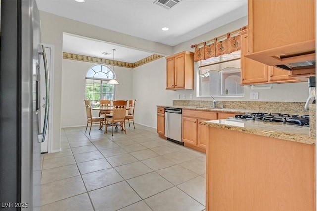 6039 Tokara Ave, Las Vegas, NV 89122 - kitchen with appliances with stainless steel finishes, a sink, light tile patterned floors, light brown cabinets, and light stone counters