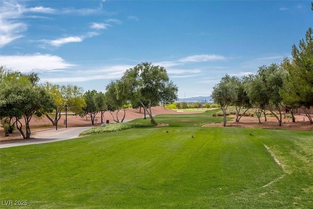 6039 Tokara Ave, Las Vegas, NV 89122 - surrounding community featuring a yard, view of golf course, and a mountain view