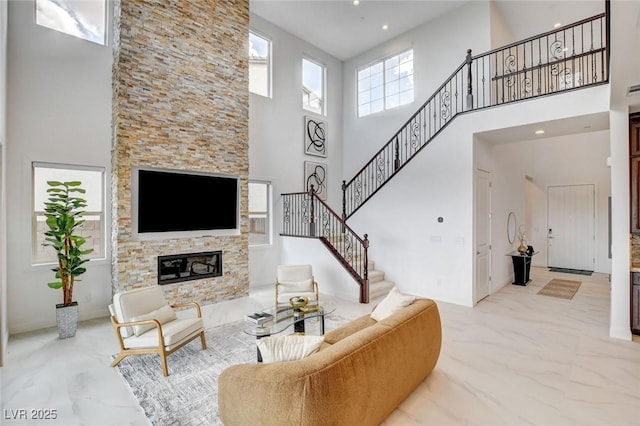 350 Gandara St, Las Vegas, NV 89138 - living area with a high ceiling, a fireplace, stairway, and baseboards