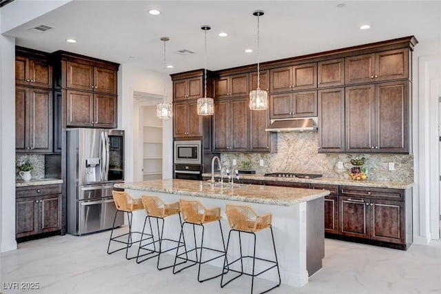 350 Gandara St, Las Vegas, NV 89138 - kitchen featuring appliances with stainless steel finishes, a sink, recessed lighting, a kitchen breakfast bar, and a kitchen island with sink