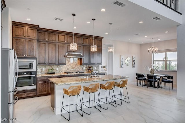 350 Gandara St, Las Vegas, NV 89138 - kitchen featuring stainless steel appliances, a sink, tasteful backsplash, recessed lighting, and a kitchen bar