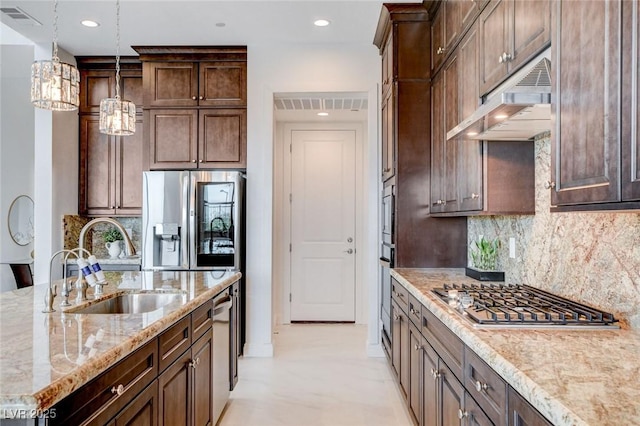 350 Gandara St, Las Vegas, NV 89138 - kitchen with stainless steel appliances, a sink, under cabinet range hood, hanging light fixtures, and light stone countertops